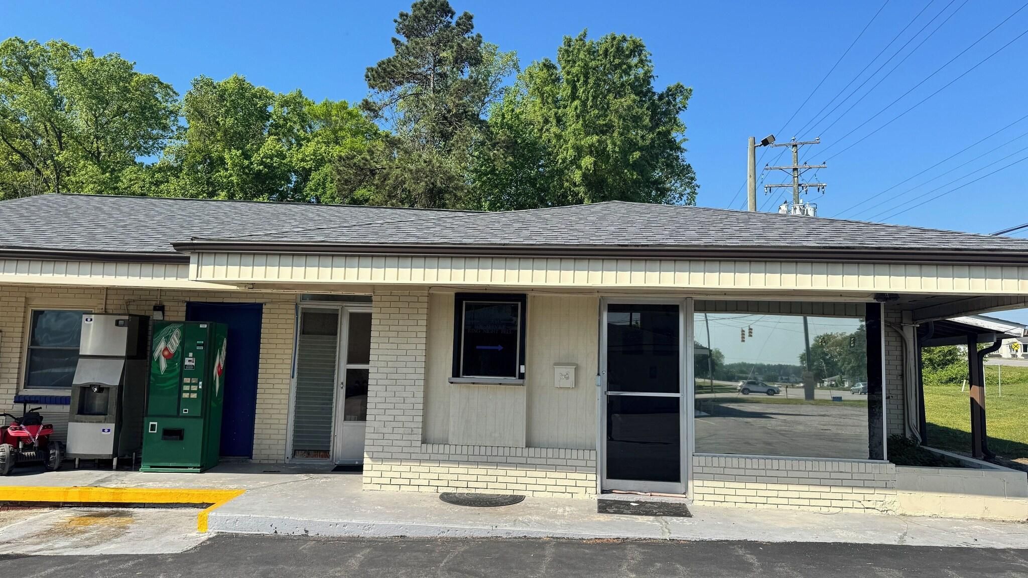 A small building with a single door, a window, and a vending machine.