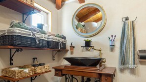 A bathroom with a vintage sink, wooden shelves, a mirror, and a towel rack. - Holiday Home Rider - Two Bedroom Holiday Home With Outdoor Pool (Sibenik)