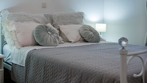 A neatly made bed with a quilted bedspread, two pillows, and a lace headboard. - Holiday Home Rider - Two Bedroom Holiday Home With Outdoor Pool (Sibenik)