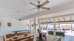 A modern kitchen with a pool table, a coffee machine, and a ceiling fan. - Villa Blanka - Six Bedroom Villa With Swimming Pool and Sea View (Podgora)