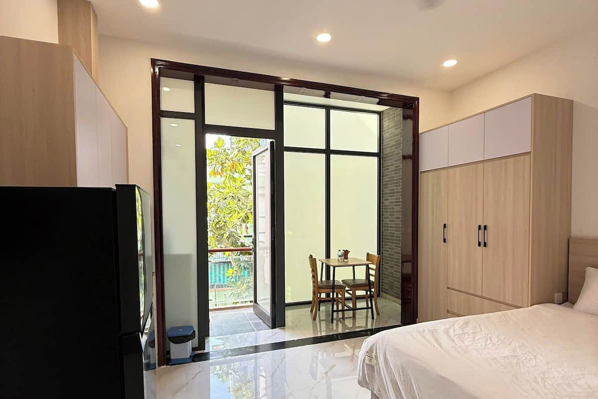 Studio, Balcony, City View | Living area | 50-inch flat-screen TV with cable channels
