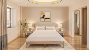 A modern bedroom with a large bed, bedside lamps, a wall-mounted artwork, and a potted plant. - Houyam Location (Flemalle)