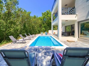 A modern building with a swimming pool, lounge chairs, and a covered outdoor area. - Wellness Villa- Four Bedroom Villa With Swimming Pool (Vinodol)