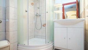 A bathroom with a glass-enclosed shower, a white sink, and a cabinet. - Apartments Ana &amp; Bogdan - Two Bedroom Apartment With Terrace (Postira)