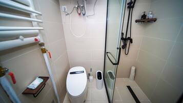Un baño moderno con inodoro, bidé y ducha.
