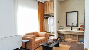 A modern living room with a sofa, coffee table, and a fireplace. - FAYU-ecovillage (Yichun)