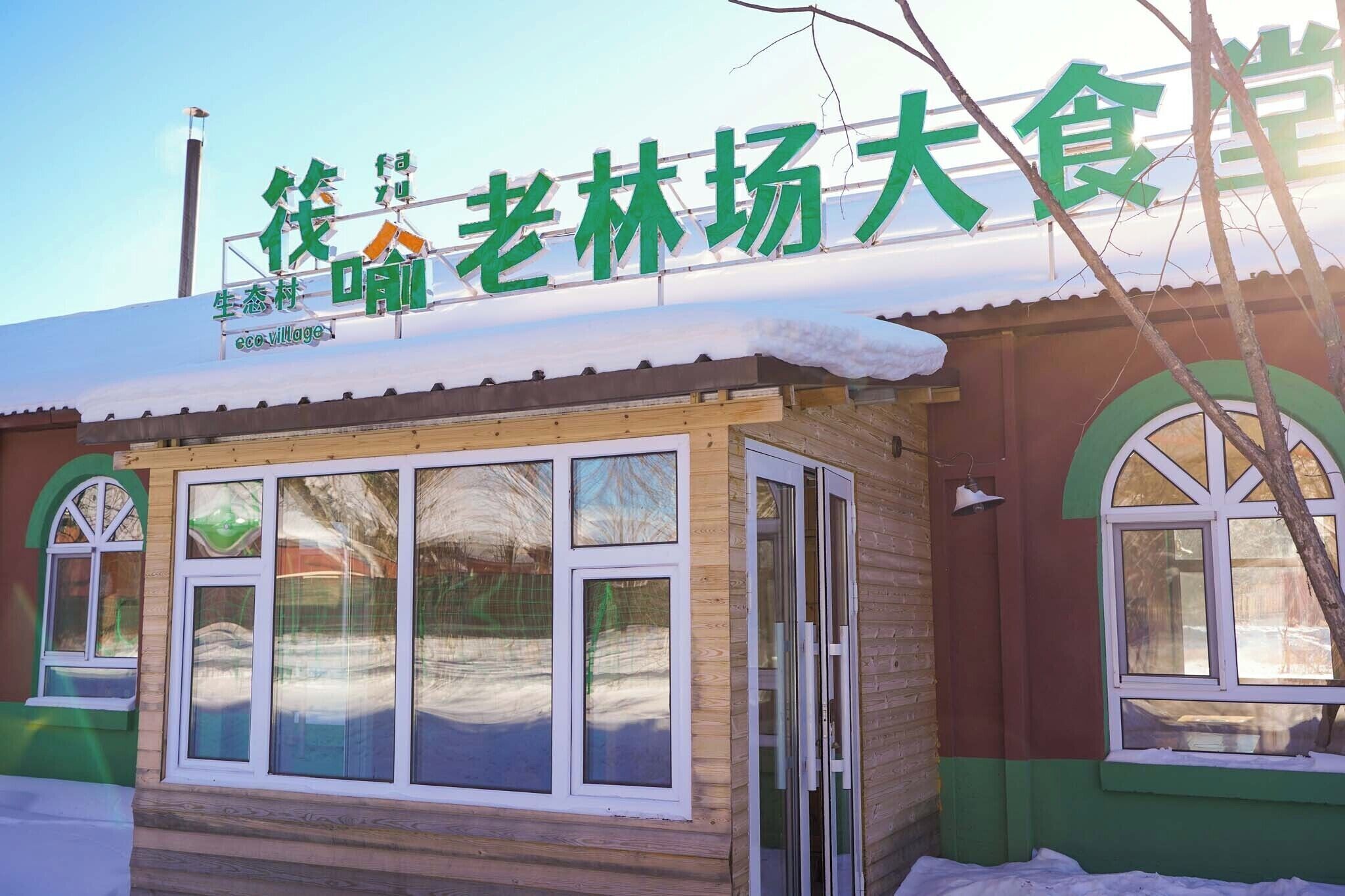 Un edifici amb un rètol que diu '生态村' i 'eco-village' en anglès.