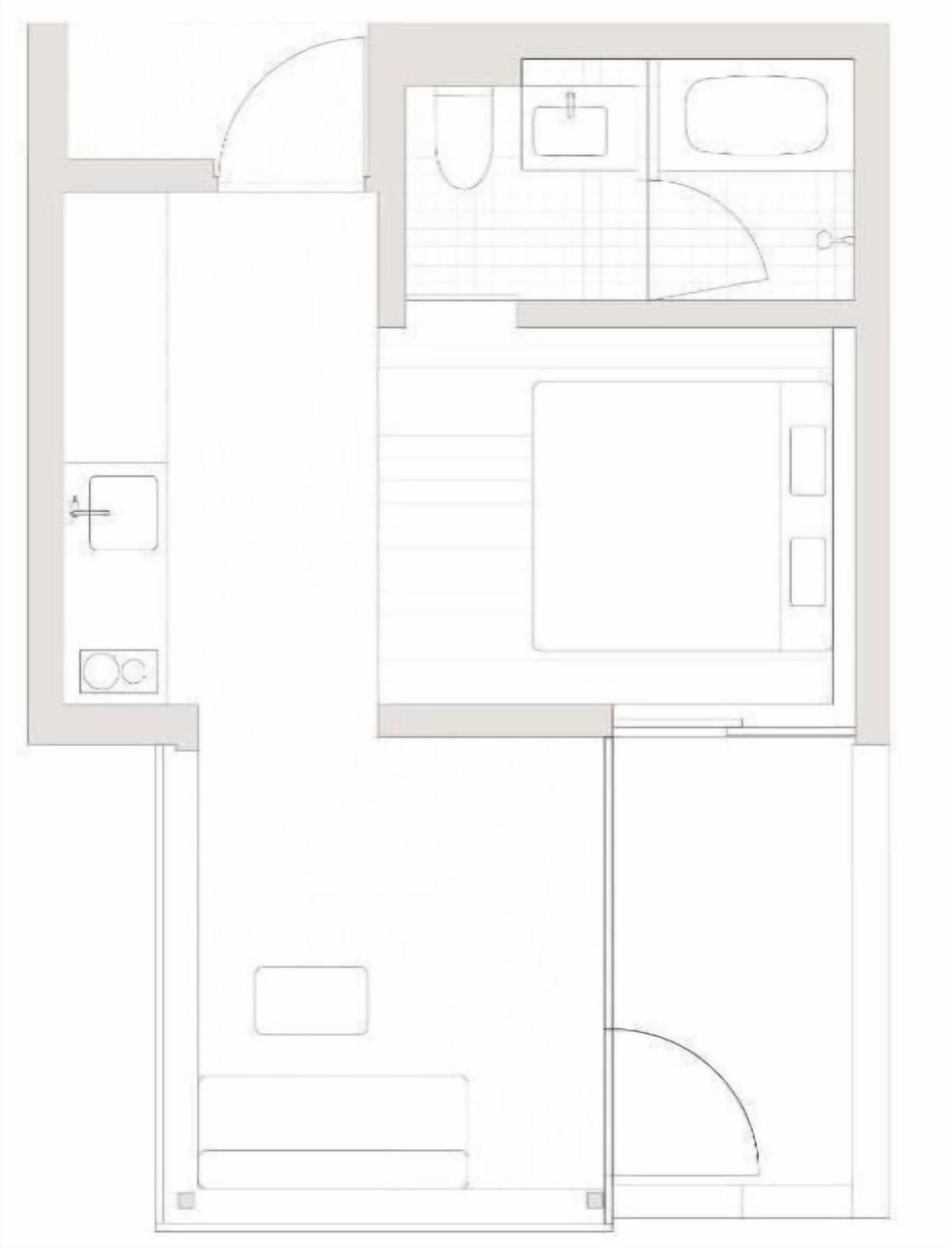 A floor plan of a hotel room with a bathroom, a small kitchenette, and a seating area.