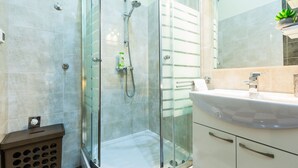 A modern bathroom with a glass shower enclosure, a white sink, and a mirror. - Charming and Historic Old Town Apartments - Twin Room (Zadar)