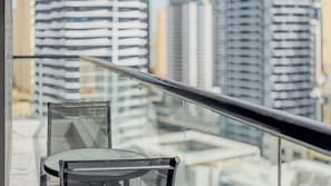 A view of a cityscape through a window with a metal railing. - Escan Tower- Dubai Marina (Dubai)