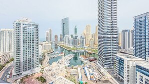 A high-rise urban area with modern architecture, a marina with boats, and a clear sky. - Escan Tower- Dubai Marina (Dubai)