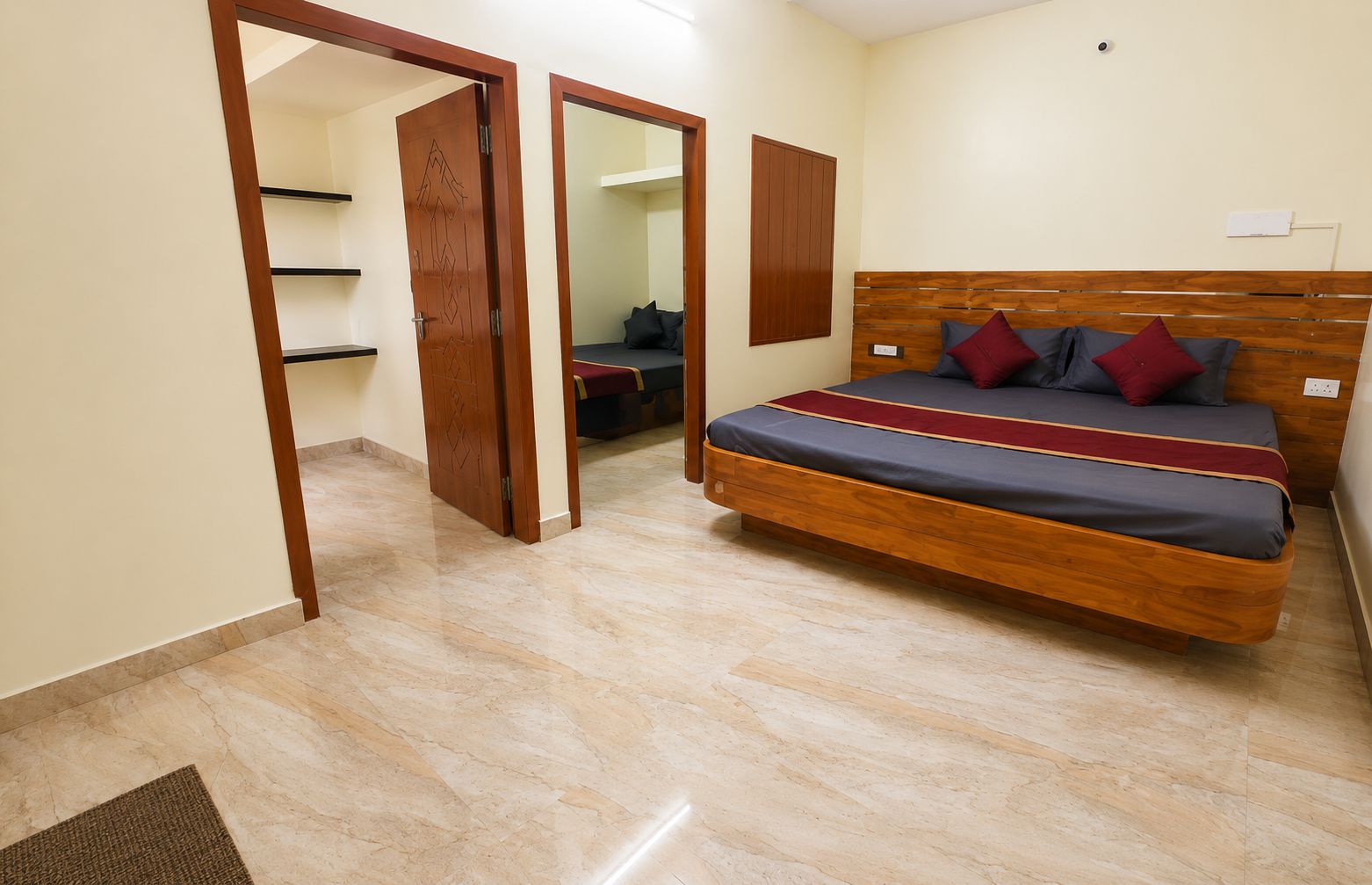 A bedroom with a wooden bed, a wardrobe, and a mirror.