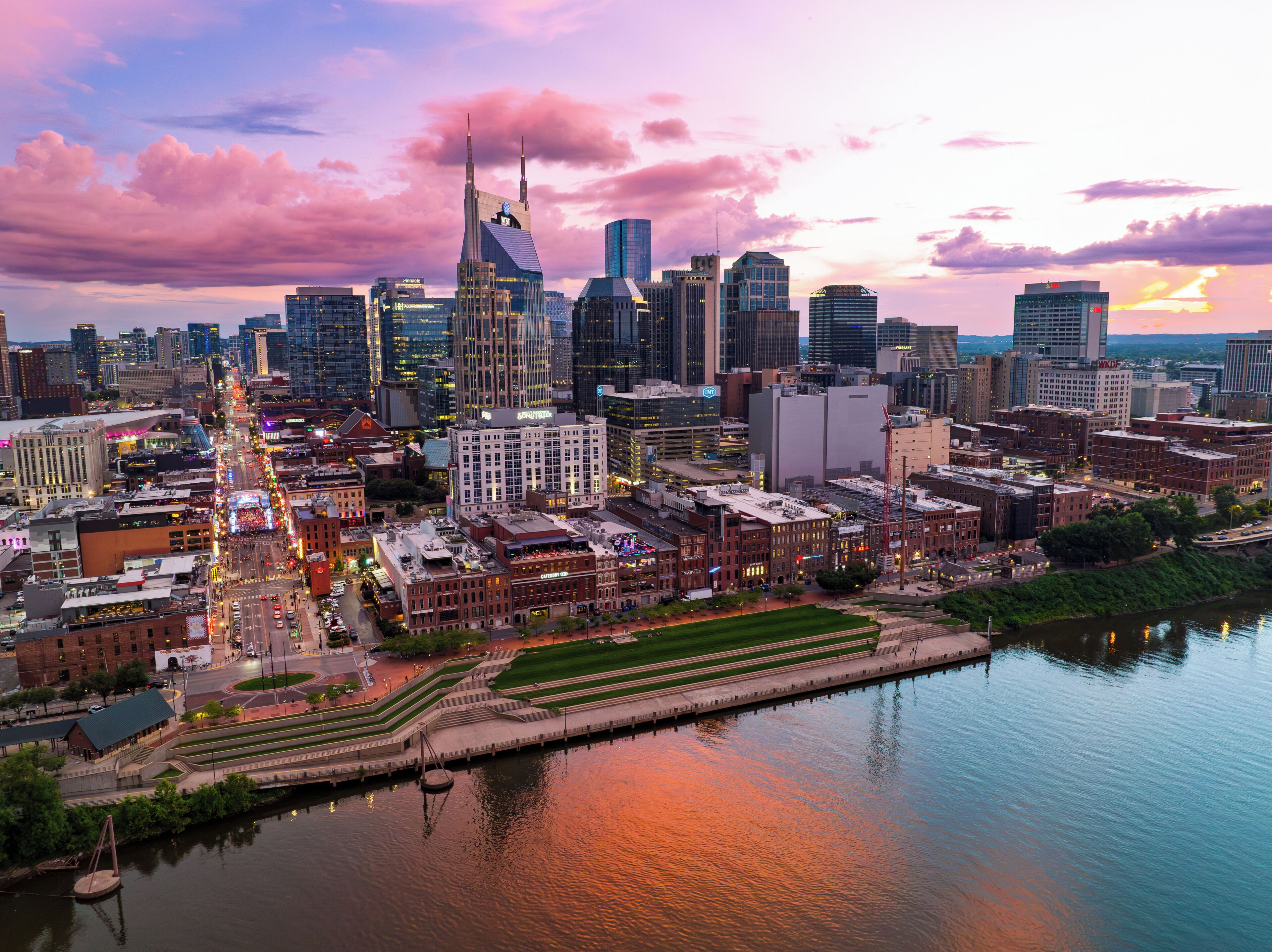 A cityscape with a river, modern buildings, and a mix of architectural styles.