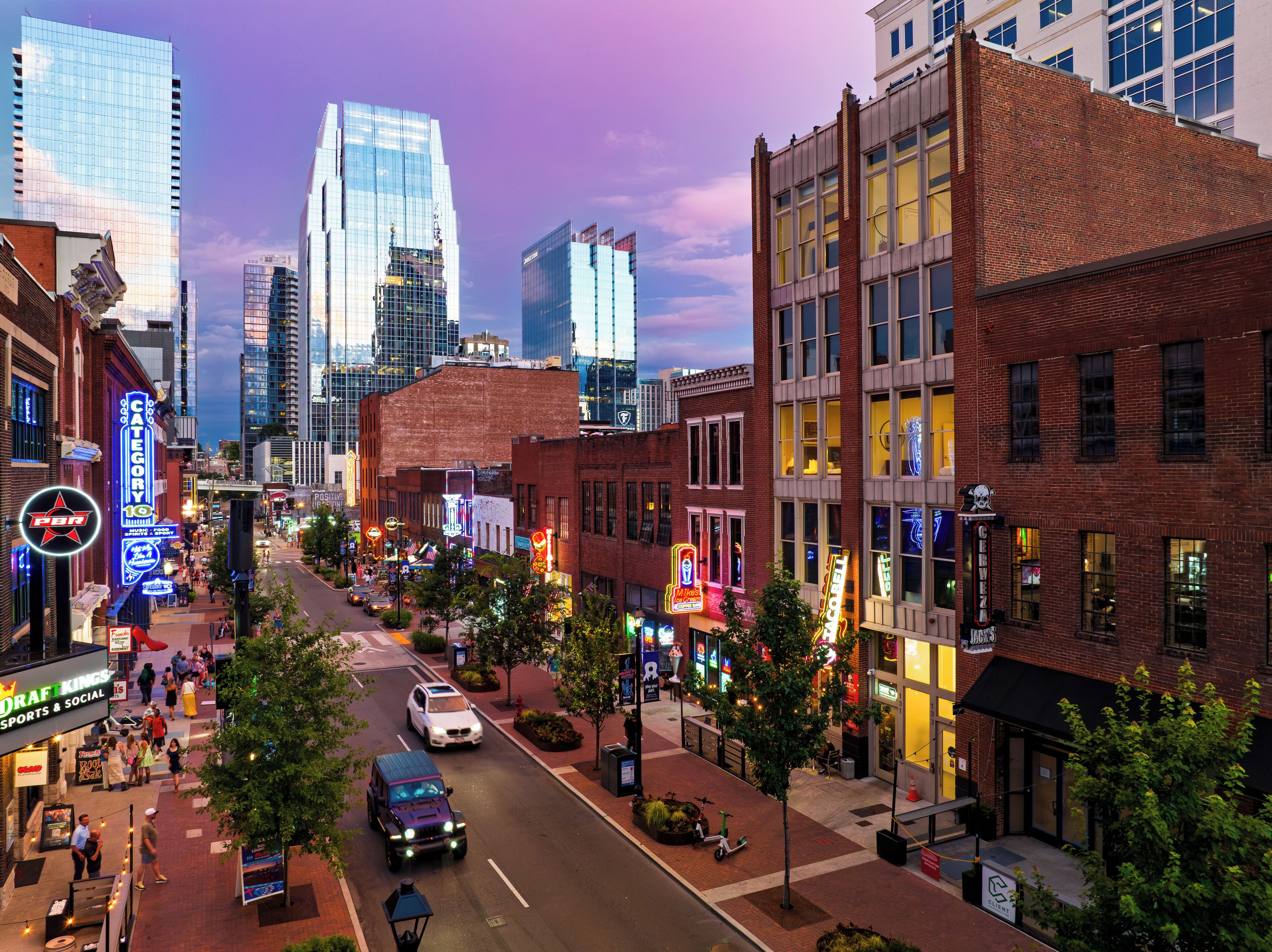 A city street with buildings, cars, and pedestrians.