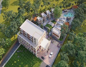 A modern hotel with a central courtyard, multiple guest rooms, and a swimming pool.