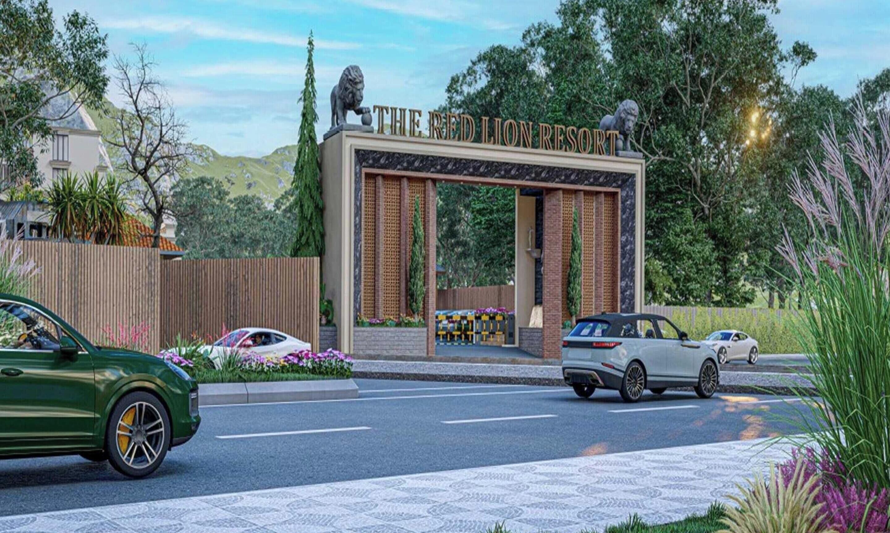 Um edifício moderno com um letreiro de entrada em destaque, uma estátua de leão e um caminho de acesso pavimentado com carros estacionados.