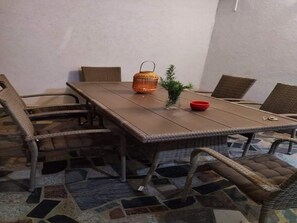 A dining area with a long table, wicker chairs, a small potted plant, and a red bowl. - Apartment Barbara - Two Bedroom Apartment With Terrace (Vir)