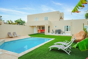 A modern two-story house with a swimming pool, outdoor seating, and a well-maintained lawn. - Luxury 3BR Pool Villa • 3 Baths • Villa Twin B (Noord)