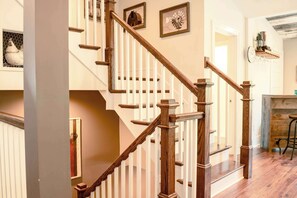 A wooden staircase with white balusters and a handrail, leading to an upper floor. - Abbey Springs Pool & Beach Condo (Fontana)