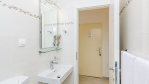 A modern bathroom with a white sink, a mirror, and a toilet. - Rooms Batina - Double Room-1 (Dubrovnik)
