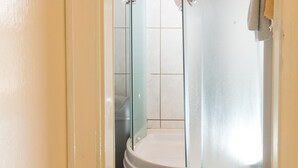 A glass-enclosed shower stall with a white door and a towel rack on the wall. - Plavi Zal Apartment - One Bedroom Apartment With Two Terraces (Dubrovnik)