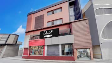 A modern building with a storefront, a company-serviced sign, and a clear sky.