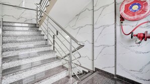 A staircase with a metal handrail and marble walls. - Collection O K R Puram (Bangalore)