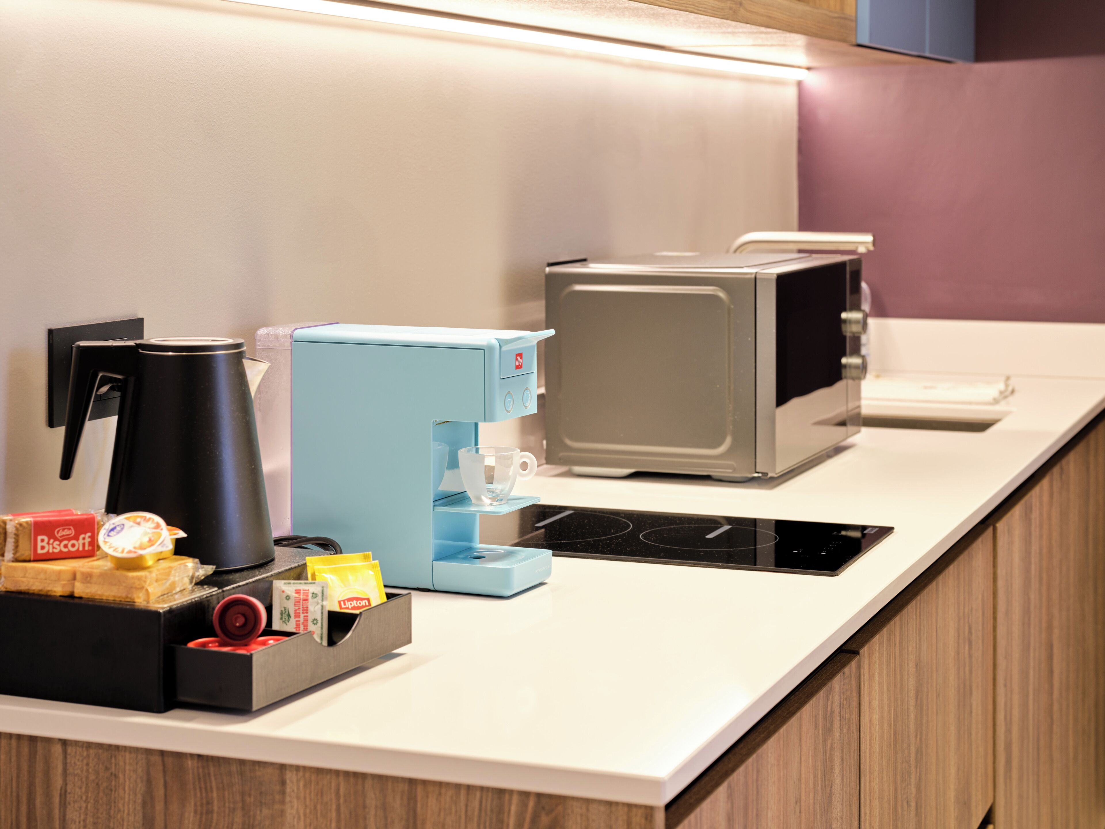 A kitchen counter with a coffee maker, a toaster, and a microwave.