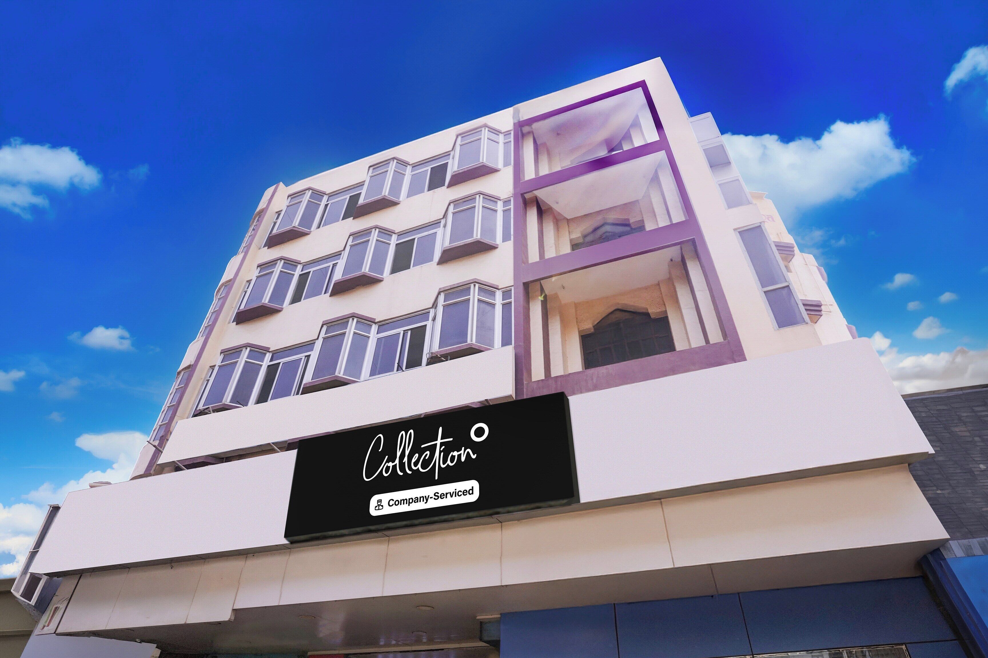A multi-story building with a sign that reads 'Collection Company-Service.'