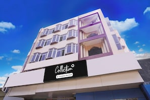 A multi-story building with a sign that reads 'Collection Company-Service.'
