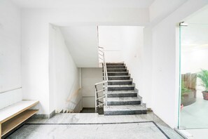 A staircase with a metal handrail leading to a landing. - Collection O Peenya 2nd stage (Bengaluru)