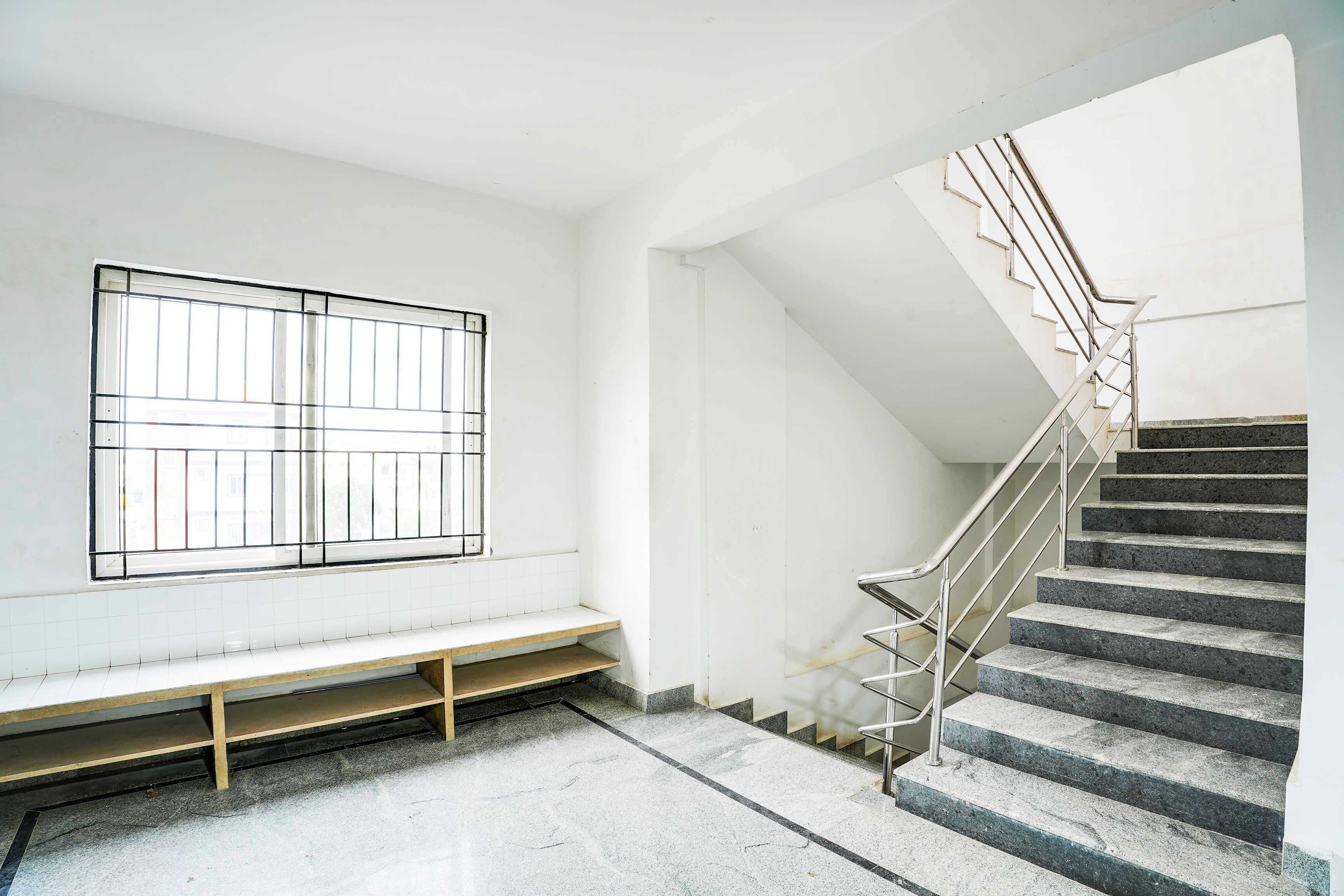 A staircase with metal railings leading to a landing.