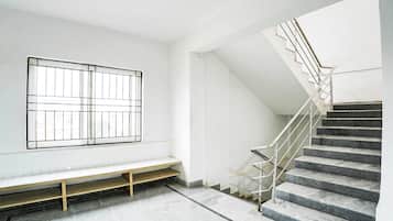 A staircase with metal railings leading to a landing.