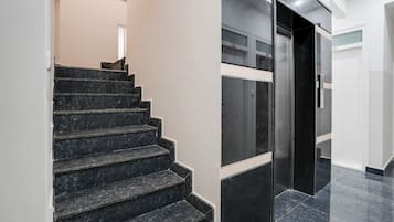 Una escalera con peldaños negros que conduce a una plataforma.
