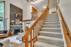 A staircase with wooden railings leading to an upper level. - 'The Blue Goose Chalet': Your Cozy Up North Escape (Gaylord)