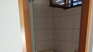 A small bathroom with a toilet, a sink, and a shower area. - Apartments Blaza - Studio Apartment (Vodice)