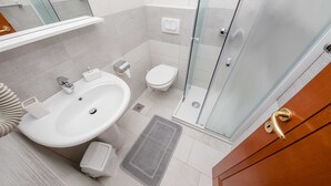A modern bathroom with a large sink, toilet, and glass shower enclosure. - Guest House Villa Anggela - Double Room With Balcony and Sea View (Rab)