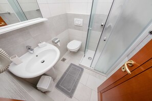 A modern bathroom with a large sink, toilet, and glass shower enclosure. - Guest House Villa Anggela - Double Room With Balcony and Sea View (Rab)
