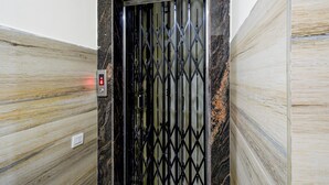 An elevator with a black metal gate and a digital display indicating the floor number. - Super Collection O Khajaguda Hills (Hyderabad)