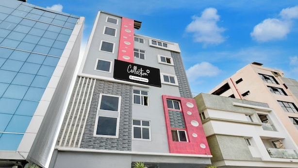 A modern building with a prominent 'Collection' sign, multiple windows, and a mix of architectural styles. - Super Collection O Khajaguda Hills (Hyderabad)
