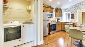 A modern kitchen with a stove, oven, microwave, and refrigerator. - Walk to Waynesville Hot Spots! 'Woodland Cottage' (Waynesville)