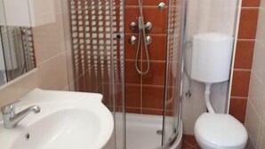 A bathroom with a shower enclosure, a sink, and a toilet. - Apartments Libertas - One Bedroom Apartment With Terrace and Sea View- (Rogoznica)