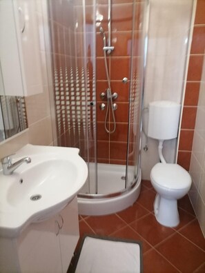 A bathroom with a shower enclosure, a sink, and a toilet. - Apartments Libertas - One Bedroom Apartment With Terrace and Sea View- (Rogoznica)