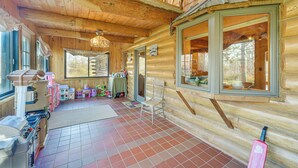 A log cabin with a kitchen area, a dining table, and a chair. - Secluded Log Cabin < 1 Mi to Munger State Trail! (Finlayson)