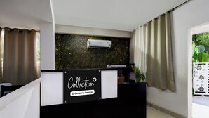 A reception desk with a sign indicating 'Collection' and 'Company-Serviced'. - Collection O Atlas DLF Formerly Hillside (Hyderabad)
