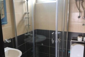 A bathroom with a glass-enclosed shower, a white sink, and a toilet. - Casa Mila Apartments - Standard Triple bedroom with sea view (Ulcinj)