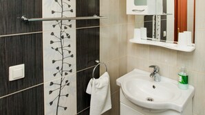 A bathroom with a white sink, a mirror, and a towel rack. - Apartments Ana Lopud - One-bedroom Apartment With Balcony and Sea View - 4 (Dubrovnik)