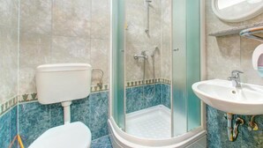 A bathroom with a glass-enclosed shower, a toilet, and a sink. - Glory Sanctuary Retreat - Triple Room with Balcony (Medugorje)