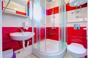 A bathroom with a glass-enclosed shower, a white sink, and a toilet. - Glory Sanctuary Retreat - Delux Double bed room with Balcony (Medugorje)