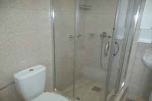 A shower enclosure with a glass door, a toilet, and a sink. - Guest House 4M Gregović - Triple bed Studio 4 (Petrovac na Moru)